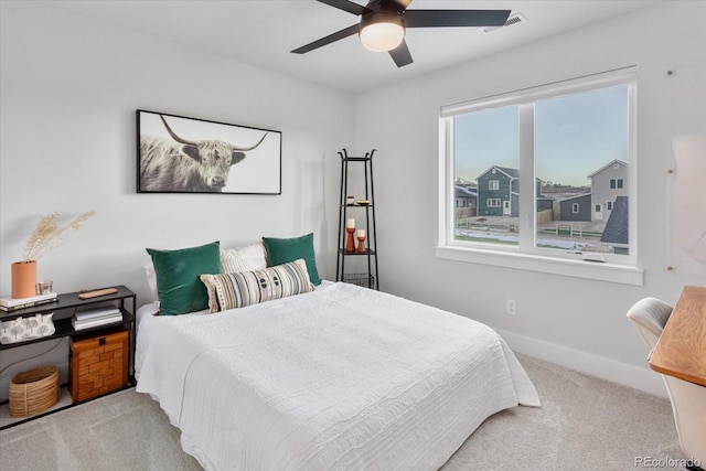 bedroom with light colored carpet and ceiling fan