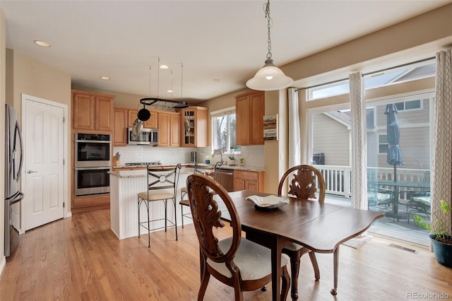 dining area featuring recessed lighting, visible vents, and light wood finished floors