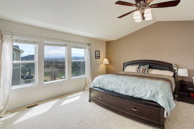 bedroom with a ceiling fan, visible vents, baseboards, lofted ceiling, and carpet flooring