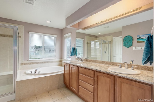 bathroom with a sink, tile patterned flooring, visible vents, a garden tub, and a stall shower