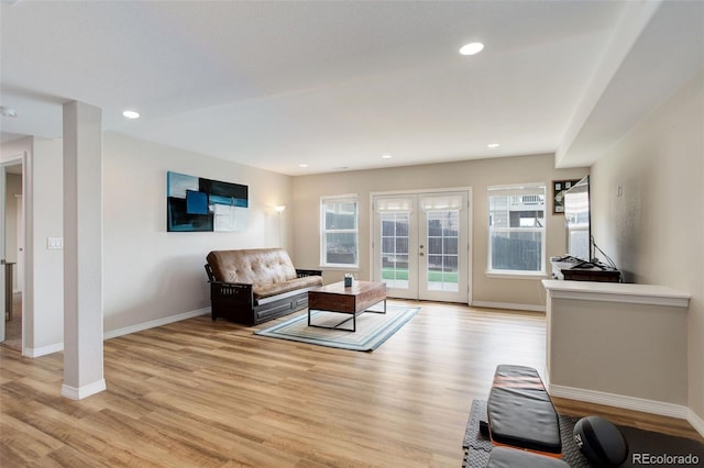 living area with french doors, recessed lighting, baseboards, and light wood-type flooring