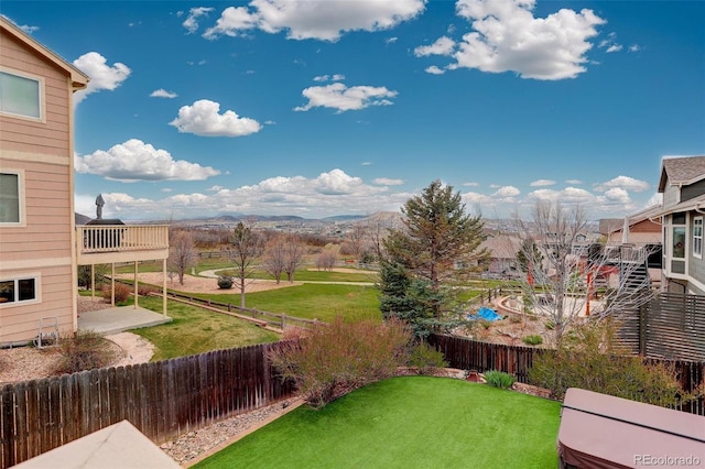 view of yard featuring a fenced backyard and a mountain view
