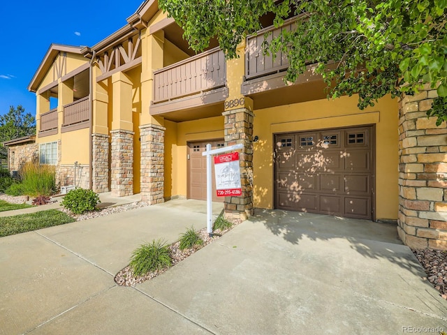 9896 W Freiburg Dr Unit 1D, Littleton, CO 80127 - view of building exterior with concrete driveway and a garage