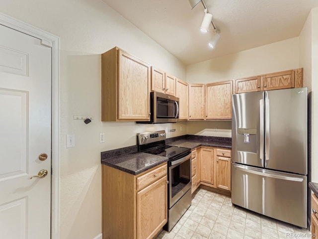 9896 W Freiburg Dr Unit 1D, Littleton, CO 80127 - kitchen featuring stainless steel appliances, light brown cabinets, track lighting, and dark stone counters
