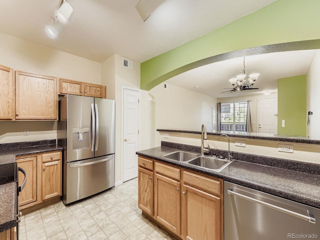 9896 W Freiburg Dr Unit 1D, Littleton, CO 80127 - kitchen with stainless steel appliances, a chandelier, arched walkways, and dark countertops