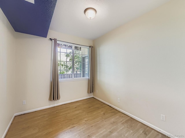 9896 W Freiburg Dr Unit 1D, Littleton, CO 80127 - spare room featuring light wood finished floors and baseboards