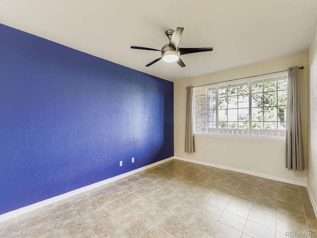 9896 W Freiburg Dr Unit 1D, Littleton, CO 80127 - spare room featuring ceiling fan and baseboards