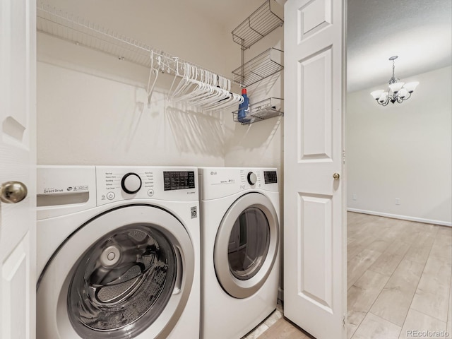 9896 W Freiburg Dr Unit 1D, Littleton, CO 80127 - washroom featuring washer and dryer, a chandelier, and light wood finished floors