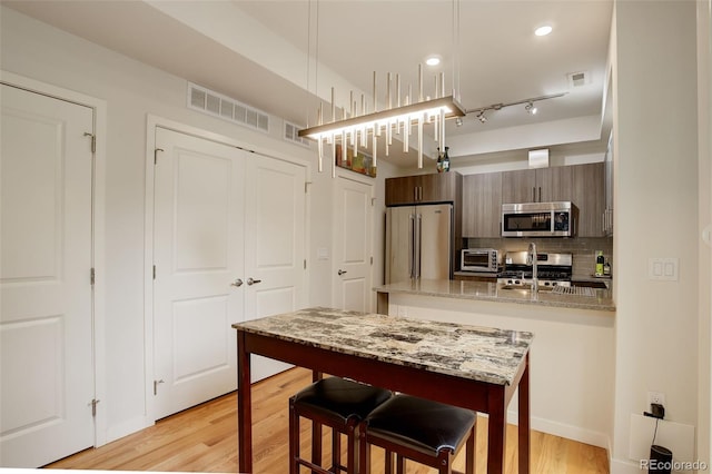 2138 N Glenarm Pl, Denver, CO 80205 - dining area featuring light wood-style floors and recessed lighting
