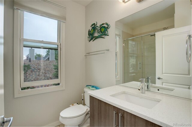 2138 N Glenarm Pl, Denver, CO 80205 - full bathroom featuring toilet, vanity, tiled shower, and baseboards