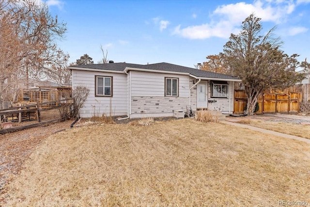 rear view of property featuring a lawn