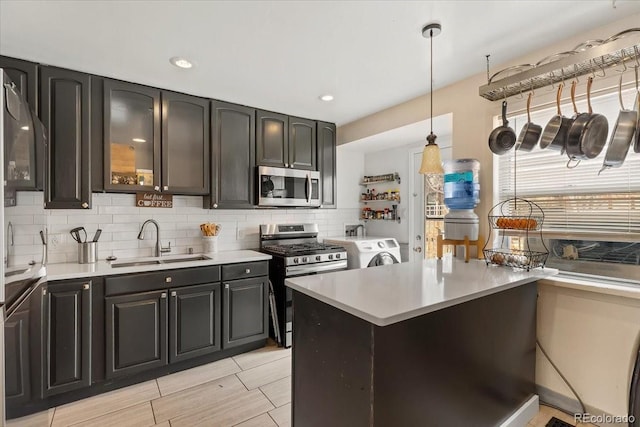 kitchen with sink, decorative light fixtures, dark brown cabinets, stainless steel appliances, and decorative backsplash