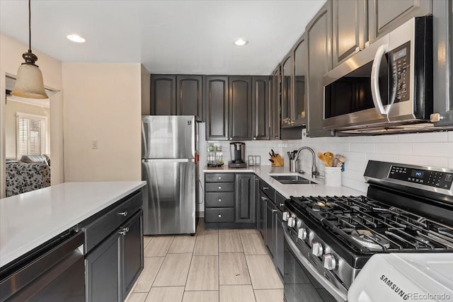 kitchen with tasteful backsplash, sink, hanging light fixtures, stainless steel appliances, and dark brown cabinets