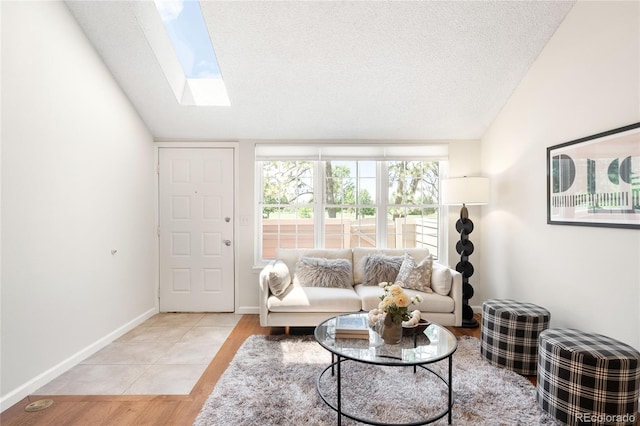 7373 E Iowa Ave Unit 1124, Denver, CO 80231 - living area featuring a skylight, lofted ceiling, a textured ceiling, and light wood-style flooring