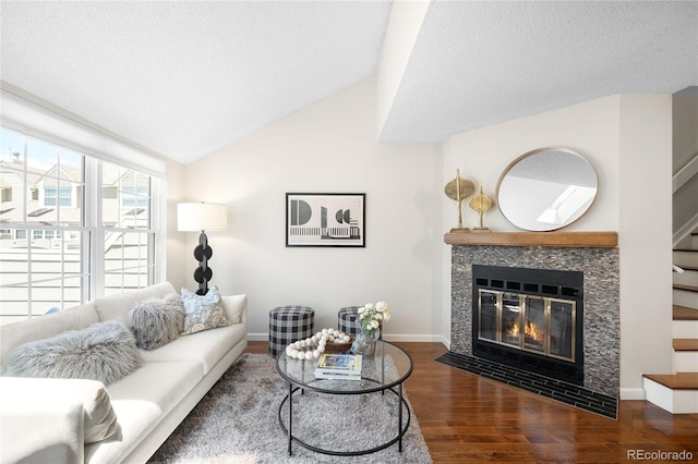 7373 E Iowa Ave Unit 1124, Denver, CO 80231 - living room featuring wood finished floors, a fireplace, stairway, a textured ceiling, and lofted ceiling