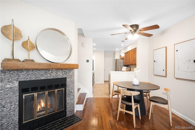 7373 E Iowa Ave Unit 1124, Denver, CO 80231 - dining space with wood finished floors, ceiling fan, a fireplace with flush hearth, and recessed lighting