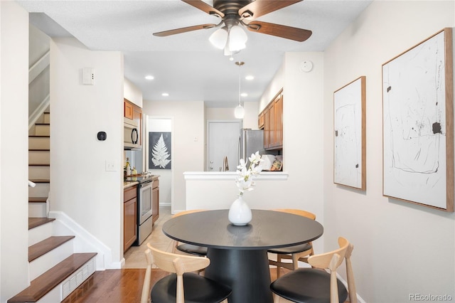 7373 E Iowa Ave Unit 1124, Denver, CO 80231 - dining space featuring stairs, a ceiling fan, light wood-type flooring, and recessed lighting