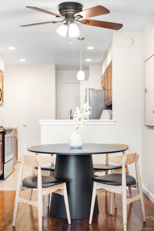7373 E Iowa Ave Unit 1124, Denver, CO 80231 - dining room with a ceiling fan, wood finished floors, recessed lighting, and a textured ceiling