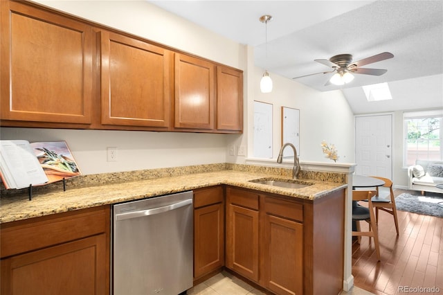 7373 E Iowa Ave Unit 1124, Denver, CO 80231 - kitchen featuring dishwasher, a skylight, brown cabinets, lofted ceiling, and a ceiling fan