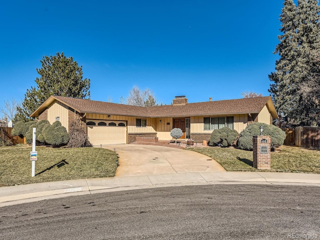 ranch-style house featuring a garage and a front lawn