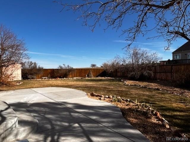 view of yard featuring a patio area and a fenced backyard