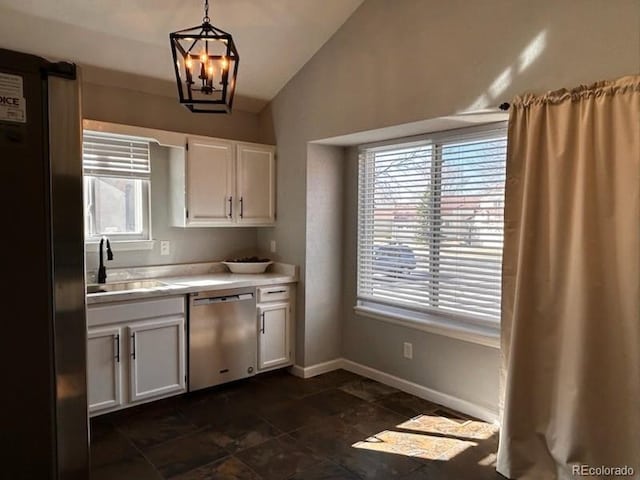 kitchen with a sink, white cabinetry, appliances with stainless steel finishes, light countertops, and vaulted ceiling