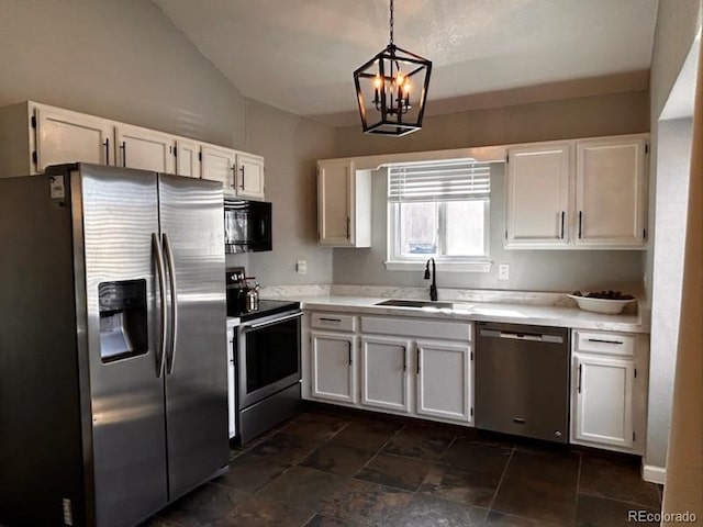 kitchen with light countertops, stainless steel appliances, an inviting chandelier, white cabinetry, and a sink