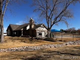 view of front of house with fence