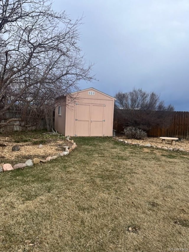 view of shed featuring fence