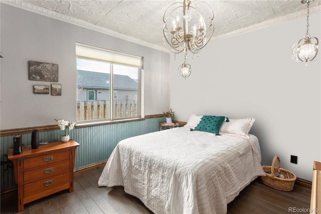 1124 E Poncha Ave, Poncha Springs, CO 81242 - bedroom with a chandelier, hardwood / wood-style floors, wainscoting, and ornamental molding