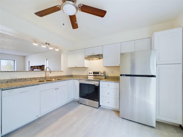 kitchen featuring light stone countertops, stainless steel appliances, sink, ceiling fan, and white cabinets