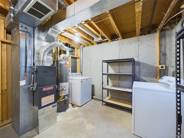 basement with gas water heater and washing machine and clothes dryer