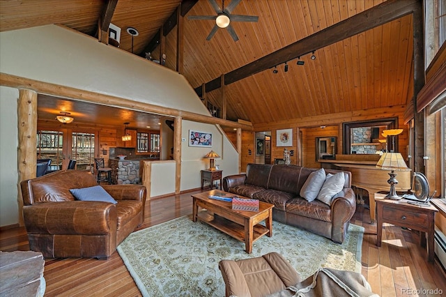 239 Aspen Pl, Evergreen, CO 80439 - living area with hardwood / wood-style floors, wooden ceiling with exposed beams, wooden walls, ceiling fan, and high vaulted ceiling