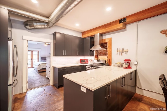 117 Elati St Unit 1, Denver, CO 80223 - kitchen featuring wall chimney exhaust hood, appliances with stainless steel finishes, a peninsula, backsplash, and light stone countertops