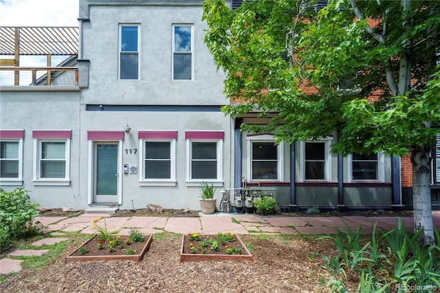 117 Elati St Unit 1, Denver, CO 80223 - view of front facade featuring a garden and stucco siding