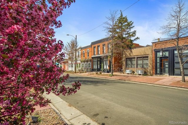 117 Elati St Unit 1, Denver, CO 80223 - view of asphalt road featuring sidewalks, street lighting, and curbs