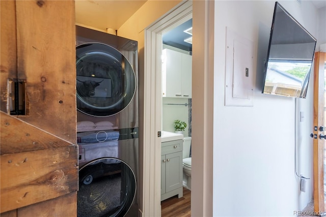 117 Elati St Unit 1, Denver, CO 80223 - laundry area with stacked washer / dryer, wood finished floors, and electric panel