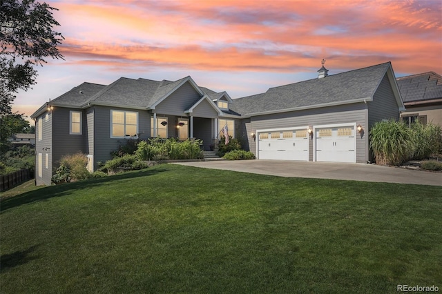 craftsman-style home featuring a yard and a garage