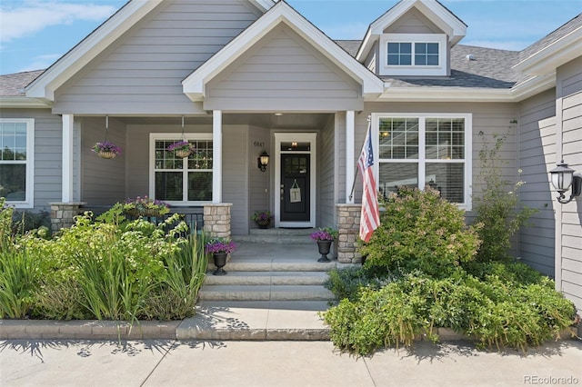 view of exterior entry with covered porch