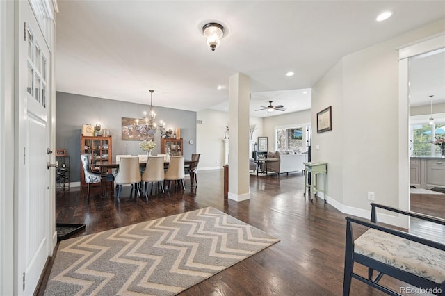 dining area with ceiling fan with notable chandelier, dark hardwood / wood-style floors, and a healthy amount of sunlight