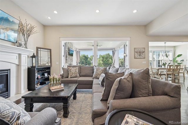 living room with ceiling fan and light hardwood / wood-style floors