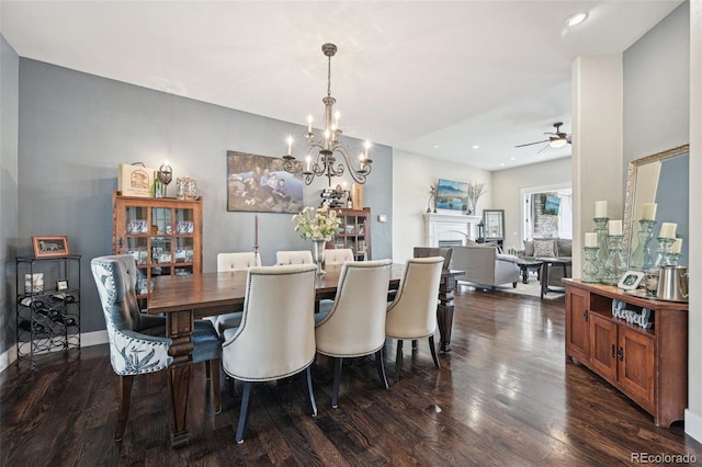 dining room featuring dark hardwood / wood-style floors and ceiling fan with notable chandelier