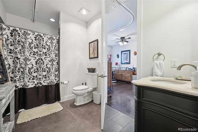 bathroom featuring tile patterned flooring, vanity, ceiling fan, and toilet