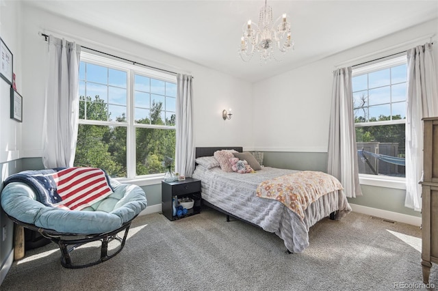 bedroom with carpet and a chandelier