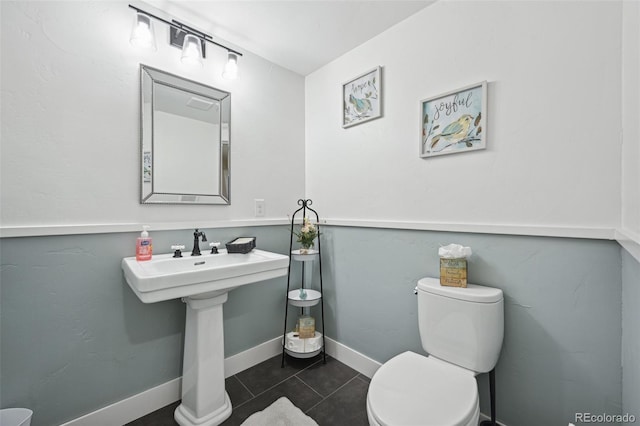 bathroom featuring toilet and tile patterned floors