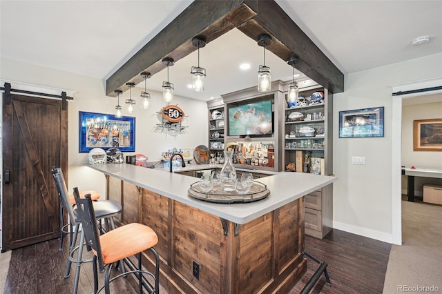 bar featuring pendant lighting, built in shelves, a barn door, and beam ceiling