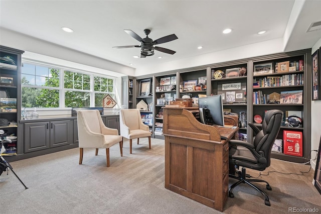 carpeted office space with ceiling fan