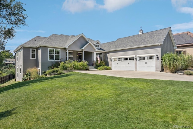 view of front of house featuring a garage and a front lawn