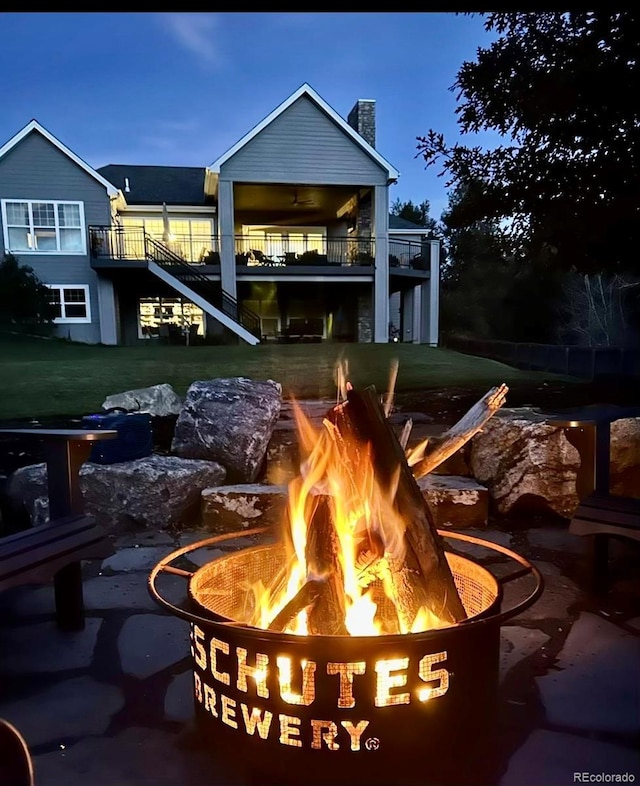 exterior space featuring a lawn and a fire pit