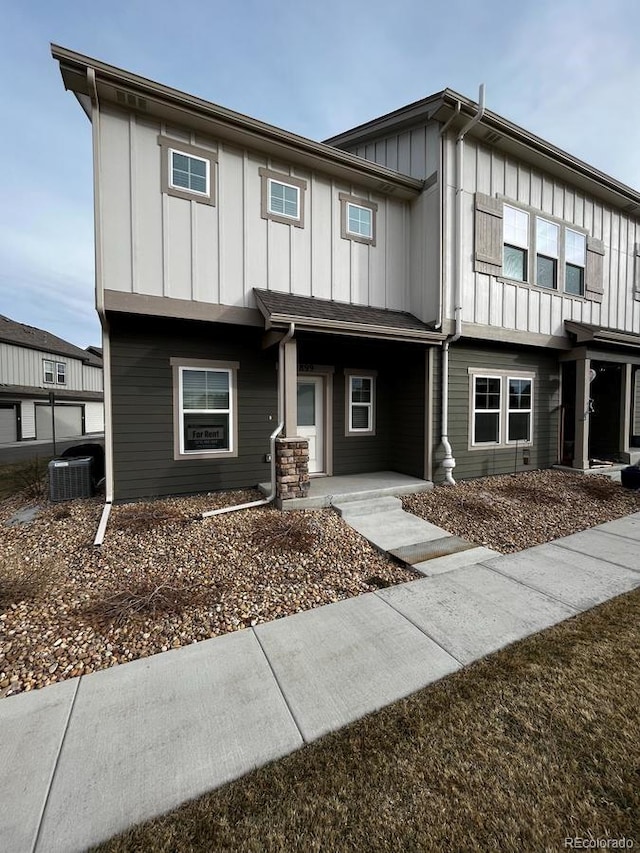 view of property featuring central AC unit and board and batten siding